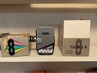 Yashica 8mm movie camera shown alongside its original box with colorful 8 logo.