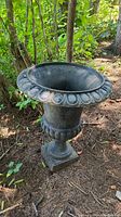 Front view of one cast iron urn showing flared rim and molded base