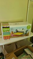 Photo of the Cricut Expression 2 electronic cutting machine box with colorful packaging and product image.