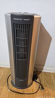 Envision Humidi/Heat tower heater front view showing vent and power cord on wooden floor
