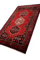 Angled full-length view of red-field rug with three medallions.