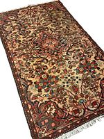 Diagonal view highlighting the texture and pile of the rug, showing the intricacy of handwoven wool and natural colors.