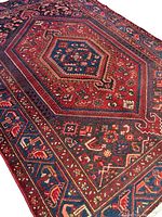 Angled view of full rug showing central hexagonal medallion and surrounding geometric patterns