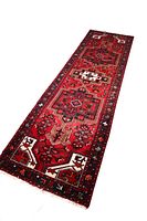 Angled view of full runner rug showing length and geometric pattern