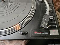 Close-up of the turntable's platter, tonearm, and control panel showing the AudioTek MTK S10 logo and PLAY/STOP button.