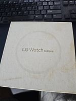 Top view of white box with LG Watch Urbane logo on lid showing branding and packaging condition.
