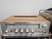 Front view of the Sherwood S-7150 CP stereo receiver showing the control knobs, tuner window, and wood casing.