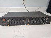 Front view of the full Tascam GT-20B equalizer showing dual-channel equalizer sliders and power switch