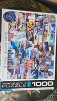 Photo of the puzzle box showing a 1000 piece jigsaw puzzle titled 'Globetrotter World' by Eurographics, featuring a collage of international landmarks and travel images on the cover.
