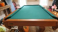 Close up of corner pocket with leather netting, pool table frame showing Windsor branding.