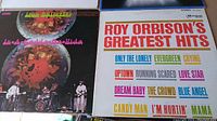 Photo showing Iron Butterfly album cover with psychedelic artwork alongside Roy Orbison's Greatest Hits LP with white cover and colorful song titles