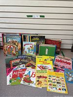 Photo of the full lot of children's books arranged standing and laid flat, showing a large variety of story and educational titles.