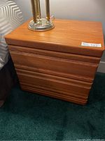 Photo of one oak side table from front showing two drawers with grooved handles