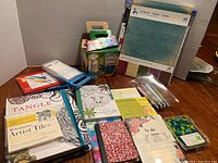 Full view of all art supplies including coloring book, cardstock paper pack, colored pencils, markers, chalk, and note pads.