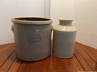 Both crocks together showing size difference and condition