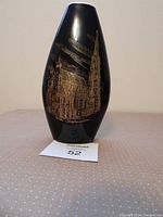 Front view of cobalt blue pottery vase with detailed gold painting of St. Stephen's Cathedral in Vienna.