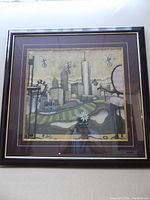 Framed print hung on a wall, shows full image and frame details including size and matting.