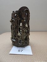 Full front view of the cylindrical ceramic candle holder showing dove details and window cutouts