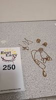 Overview of lot on grey surface showing chains, stud earrings, and threader earrings