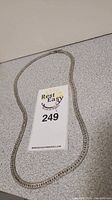 Chain laid out with auction tag showing lot number