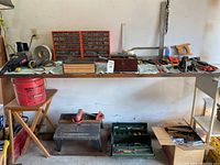 Wide shot showing overall layout of table with tools, drawers, router table, and other items grouped