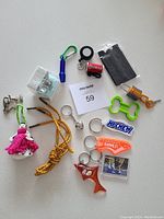 Overview of all keychains, shoelaces, and card holder included in the lot.