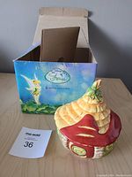 Porcelain fairy house shaped box and original colorful Royal Doulton Disney Fairies box with Tinker Bell artwork.