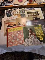 Photo showing the 10 vinyl records arranged on a table. Album covers visible include Billy Vera, Herb Alpert & The Tijuana Brass, The Three Suns, and others.