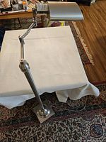 Full view of the stainless steel retro floor lamp showing its height and base design.