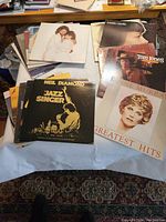 Photo showing a stack of vinyl record album covers including Neil Diamond's Jazz Singer, Anne Murray's Greatest Hits, and Tom Tones.