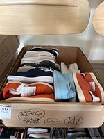 Box containing 14 pairs of size 7 men's Adidas Stan Smith sneakers in assorted colors