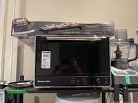 Front view of KitchenAid toaster oven with Salton hot tray box on top