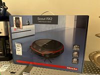 Front view of sealed Scout RX2 box with Miele branding and product image
