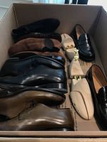 Overview of six pairs in box including loafers, lace-ups, sandals