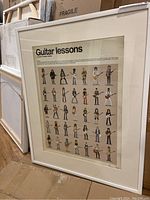 Framed artwork leaning against stacked frames