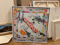 Overall front view of framed artwork leaning against wall