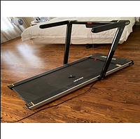 Portable treadmill set up in running position on hardwood floor