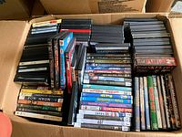 Overhead view of assorted DVD cases in one cardboard box