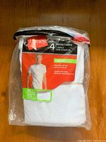 Original packaging of 4 Hanes tagless white cotton ComfortSoft T-shirts in size 34-36.
