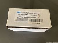 White cardboard box with label identifying EES Model 640 Direct Voltage Adaptor, made in the USA.