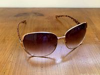 Front angled view showing large brown gradient lenses and gold-tone metal frame.