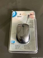 Onn travel mouse in original packaging showing the front with product information and retractable cord feature.