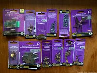 Image showing a collection of new wall hanging hardware items in original packaging arranged on a wooden surface.