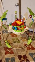 Full view of Fisher-Price Rainforest Jumperoo showing padded seat, animal toys, and frame.