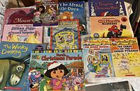 Photo of assorted scholastic children's books featuring popular characters and series with good visible condition.
