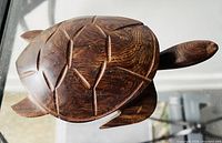 Photo of wooden turtle showing top shell detail and carved pattern.