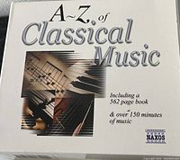 White box with title 'A-Z of Classical Music', mentions a 562-page book and over 150 minutes of music. Naxos brand is visible.