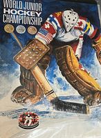 Cover of the World Junior Hockey Championship book with artwork of a vintage style hockey goalie in pads and mask with text and medals on the cover.