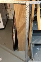 Full view of the Johnson drywall T square standing upright, showing the aluminum frame and measurement markings.