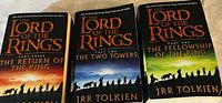 Photo of three paperback books from The Lord of the Rings trilogy by J.R.R. Tolkien showing cover art and titles.